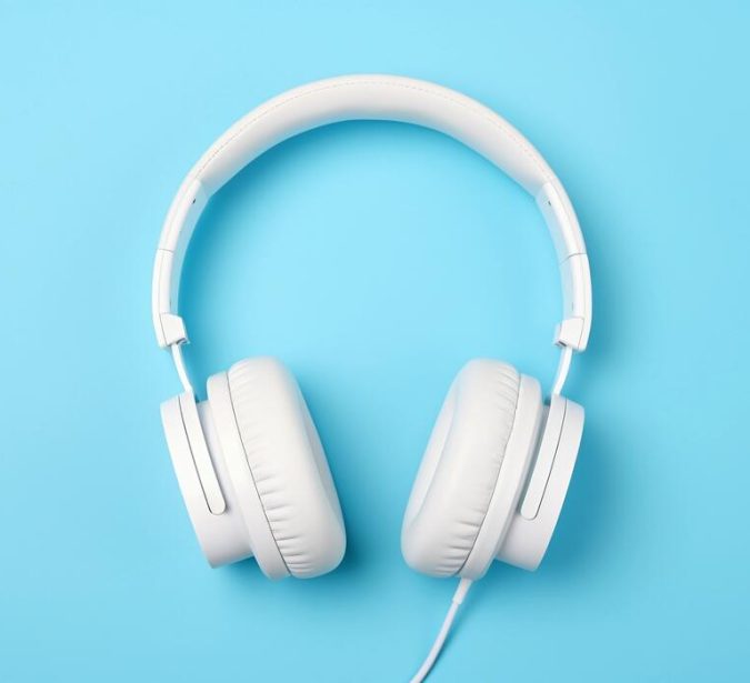 white-headphones-isolated-on-blue-background-ai-generated-photo